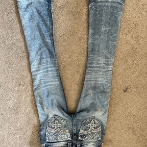 Rock Revival Light Blue Boot Cut Jeans with Fleur-de-Lis Detail